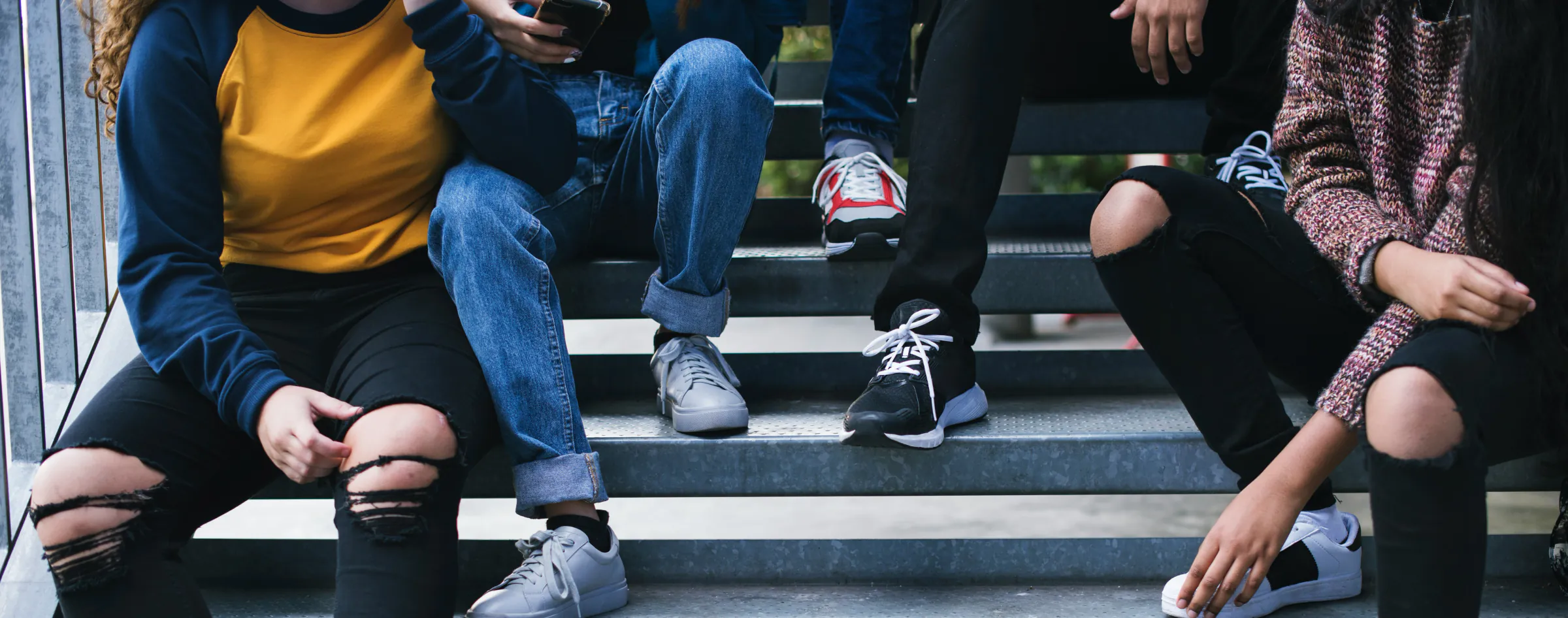 Young adults sitting together on steps