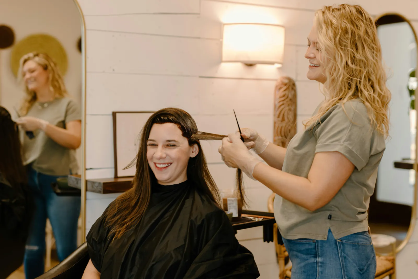 A cosmetology professional teaching a hands-on skill