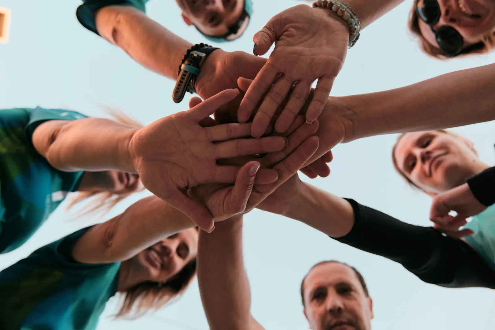 Community partners stacking their hands together