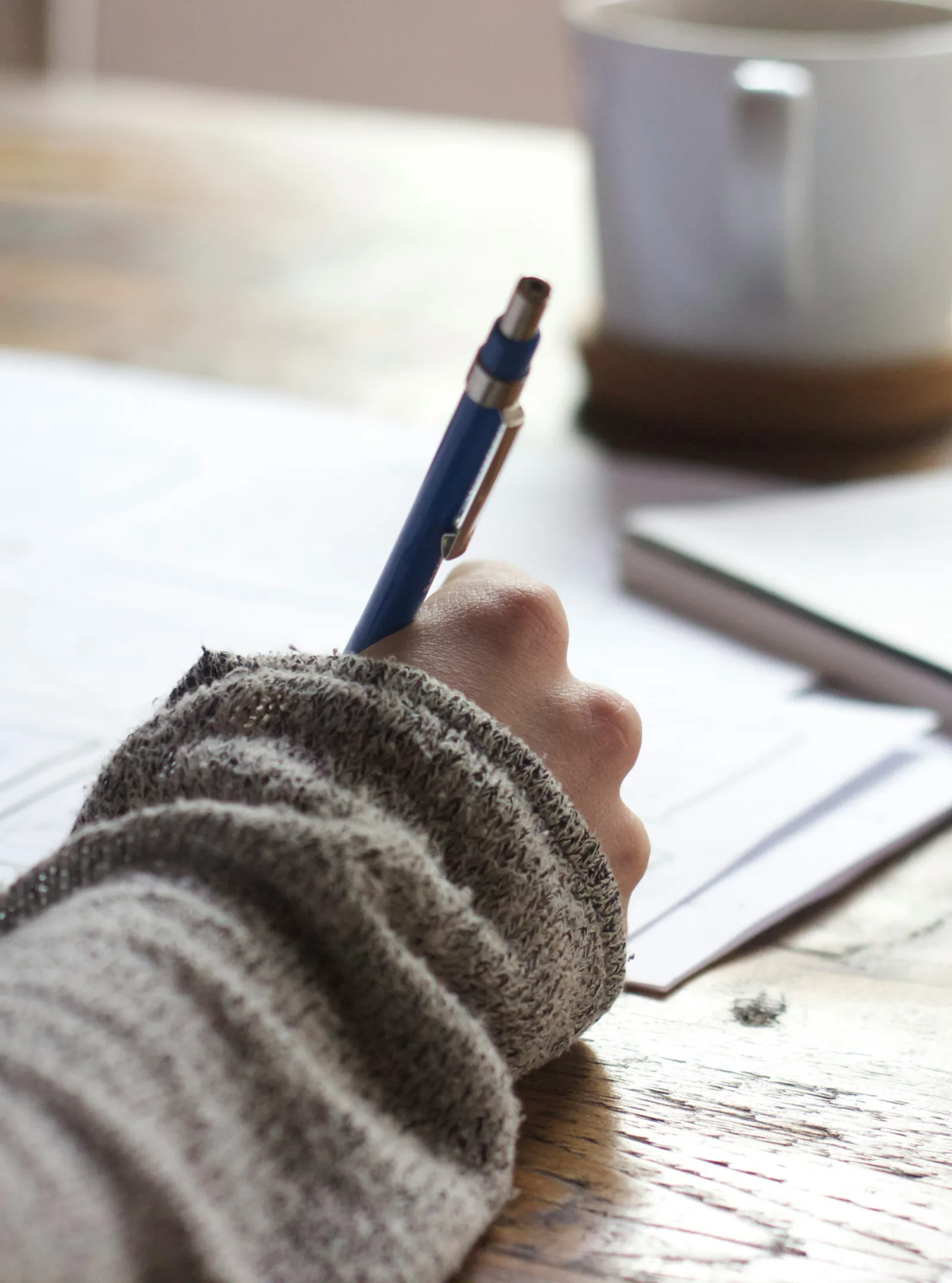 A young adult completing written coursework