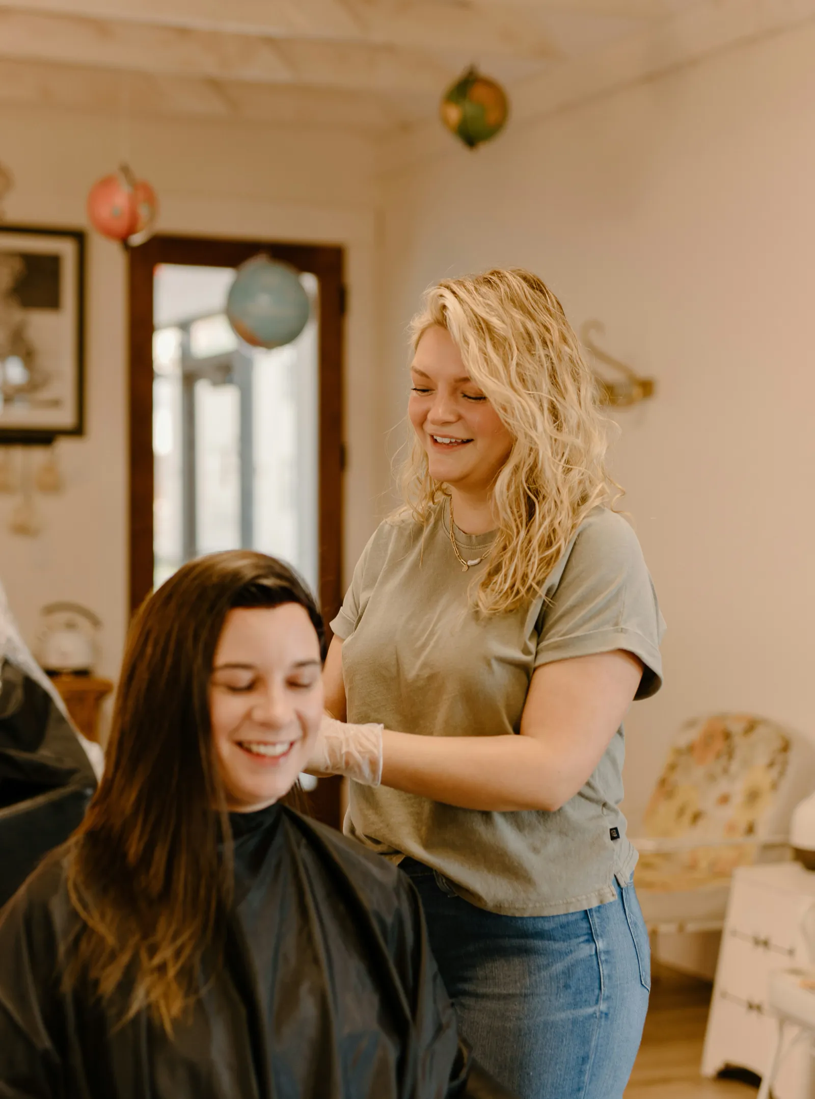 A cosmetology mentor teaching a young adult
